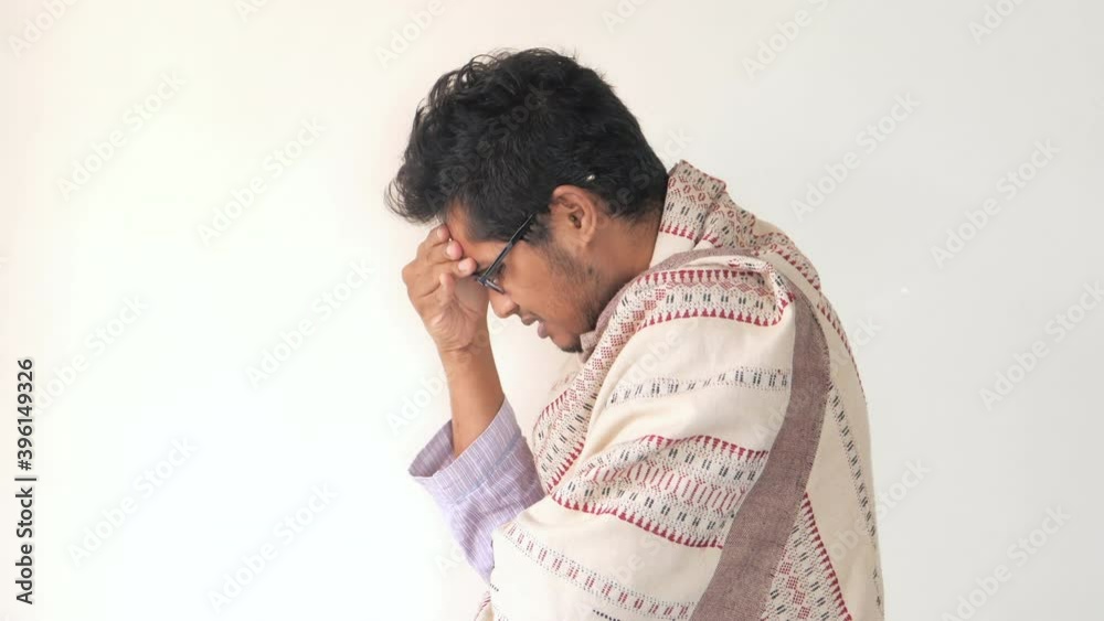  young man coughing and sneezes against white wall 