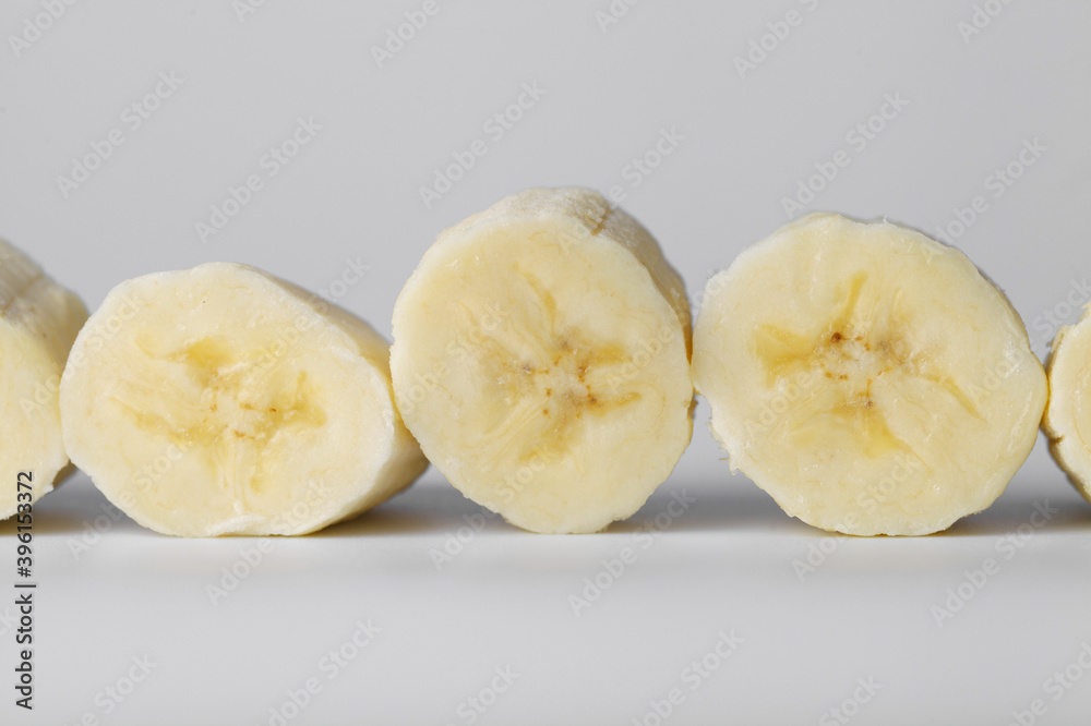 Sliced banana slices on a white background close-up Sliced banana slices on a white background close-up