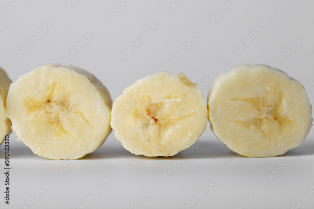 Sliced banana slices on a white background close-up Sliced banana slices on a white background close-up