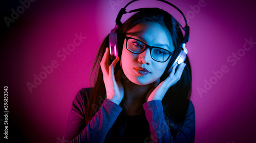 Young Asian woman dreams while listening to music - home shooting