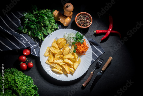 Baked potat and vegetables on dark background photo