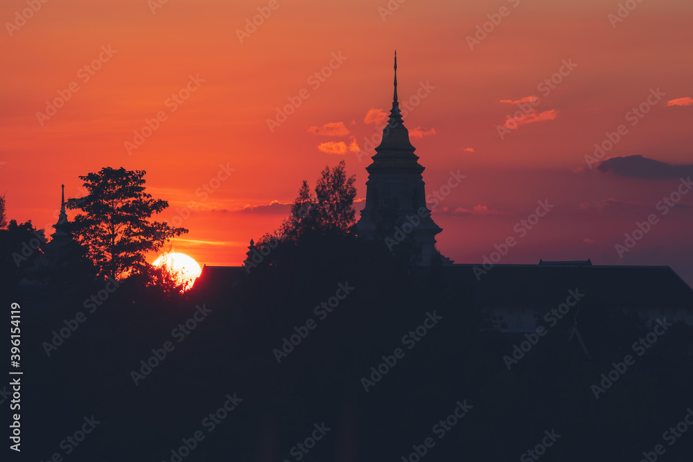 View over the temples of Chaiyaphum in Thailand to the surrounding mountains at sunset View over the temples of Chaiyaphum in Thailand to the surrounding mountains at sunset