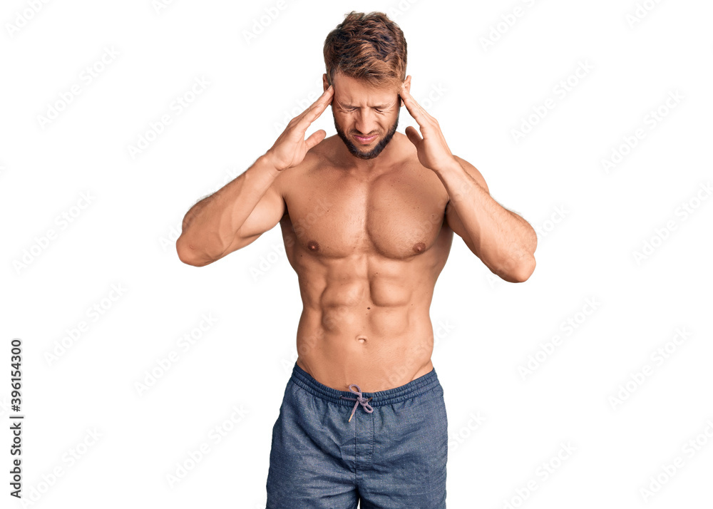 Young caucasian man standing shirtless with hand on head for pain in head because stress. suffering migraine. Young caucasian man standing shirtless with hand on head for pain in head because stress. suffering migraine.