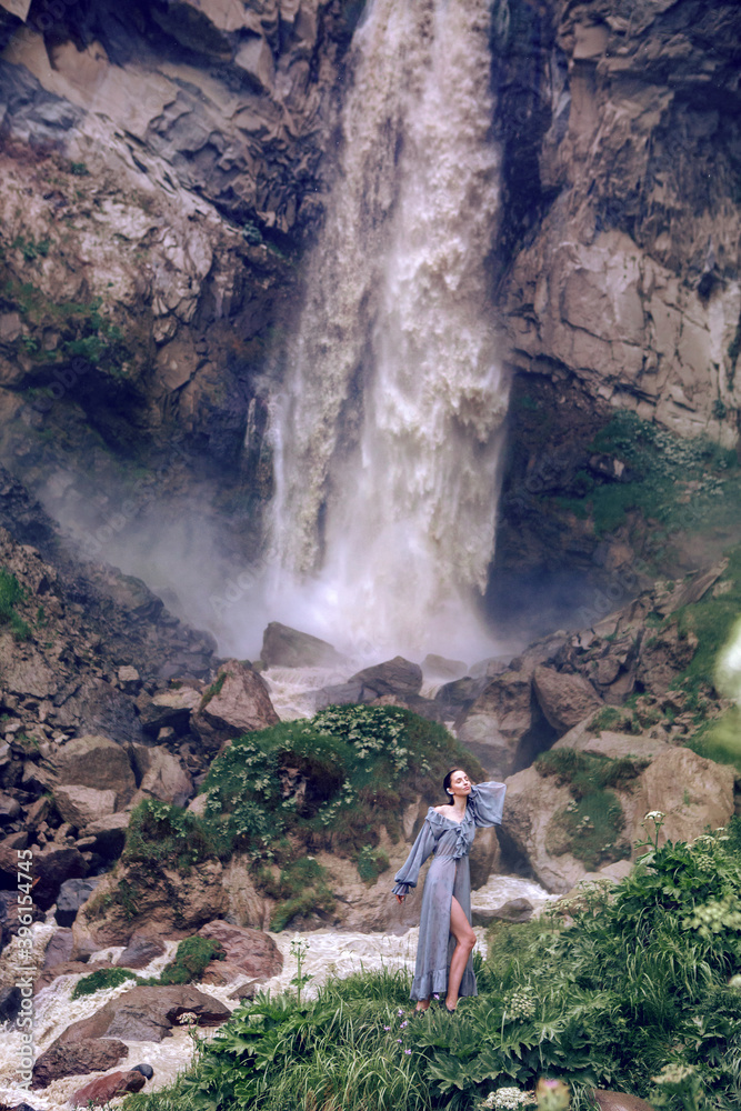high waterfall Jila-su with dirty water in summer in Russia in the North Caucasus