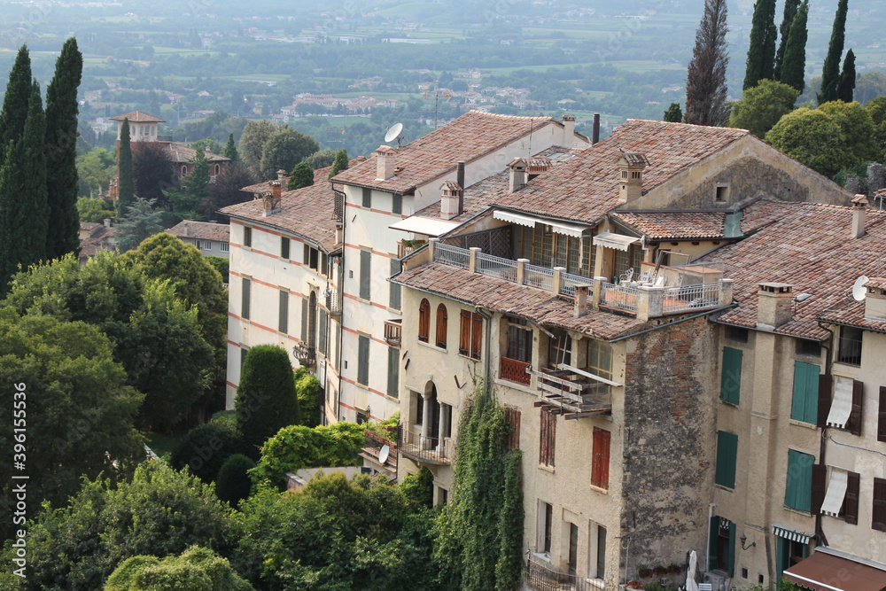 stylish buildings in an Italian town, Italian architecture, windows, yew trees and blue skies