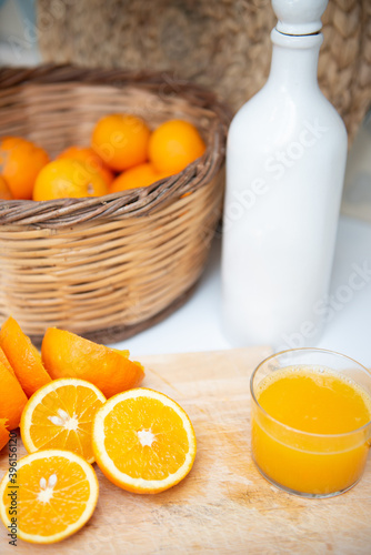 Fresh orange juice on a glass with oranges