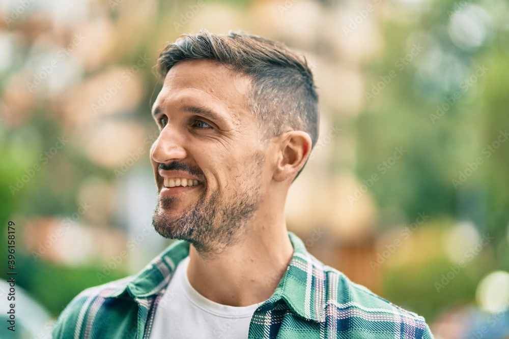 Young caucasian man smiling happy standing at the city. Young caucasian man smiling happy standing at the city.