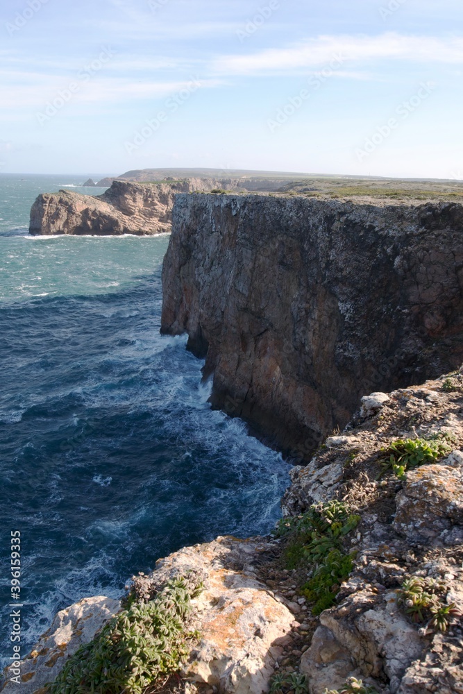 Steep cliffs into azure Atlantic Ocean in Portugal Sagres