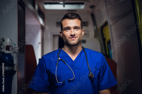A portrait of a young handsome paramedic with a stethoscope. photo