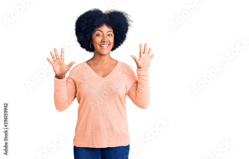 Young african american girl wearing casual clothes showing and pointing up with fingers number ten while smiling confident and happy.