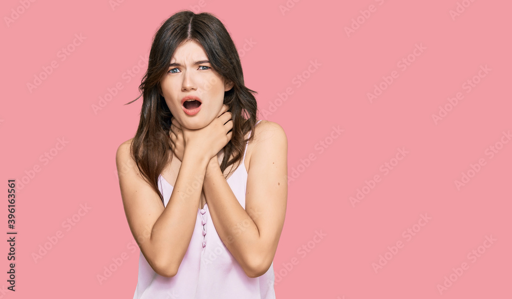 Young beautiful caucasian girl wearing casual clothes shouting and suffocate because painful strangle. health problem. asphyxiate and suicide concept. Young beautiful caucasian girl wearing casual clothes shouting and suffocate because painful strangle. health problem. asphyxiate and suicide concept.