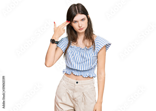 Photography Young beautiful caucasian girl wearing casual clothes shooting and killing oneself pointing hand and fingers to head like gun, suicide gesture