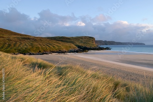 Beautiful sunrise on a sandy beach with grassland in the foreground, the Isle of Lewis, Outer Hebrides 