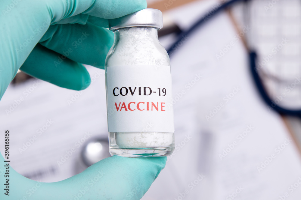 hand with sars-cov-2 coronavirus vaccine vial hand with sars-cov-2 coronavirus vaccine vial