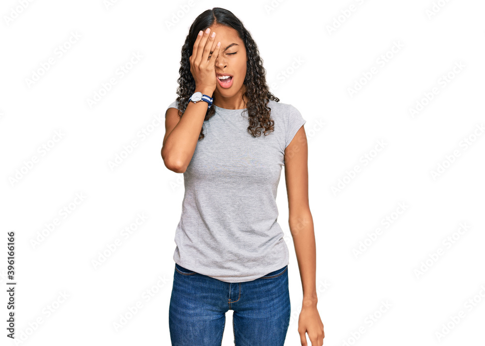 Young african american girl wearing casual clothes yawning tired covering half face, eye and mouth with hand. face hurts in pain. Young african american girl wearing casual clothes yawning tired covering half face, eye and mouth with hand. face hurts in pain.