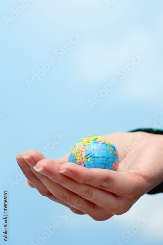 Closeup Of Hand Holding Globe