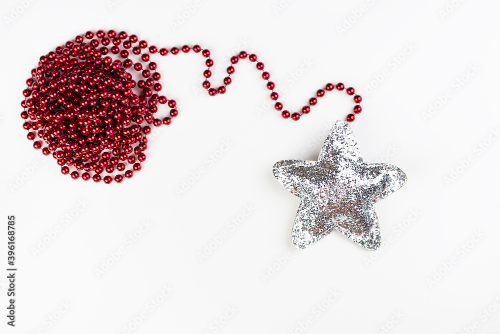 Christmas red decoration together with a shiny star in sequins isolated on a white background. Christmas red decoration together with a shiny star in sequins isolated on a white background.