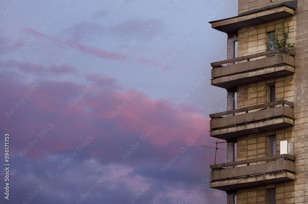 An old multi-storey building against a purple sky