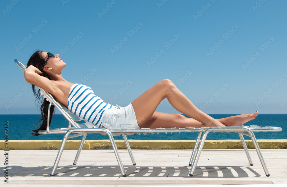 woman next to a hammock enjoying the spring or summer sun