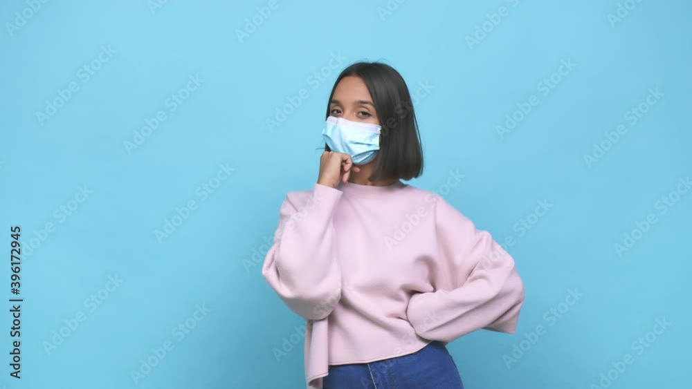 Young hispanic woman wearing antiviral mask looking sideways with doubtful and skeptical expression Young hispanic woman wearing antiviral mask looking sideways with doubtful and skeptical expression
