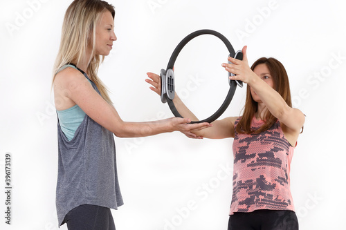 Pilates Ring upper body Workout. Fitness woman and Personal Trainer photo