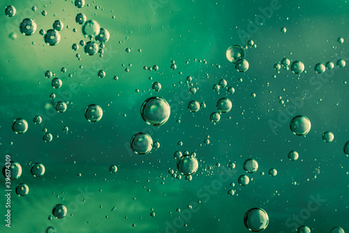  water droplets in oil, macro photo, green background