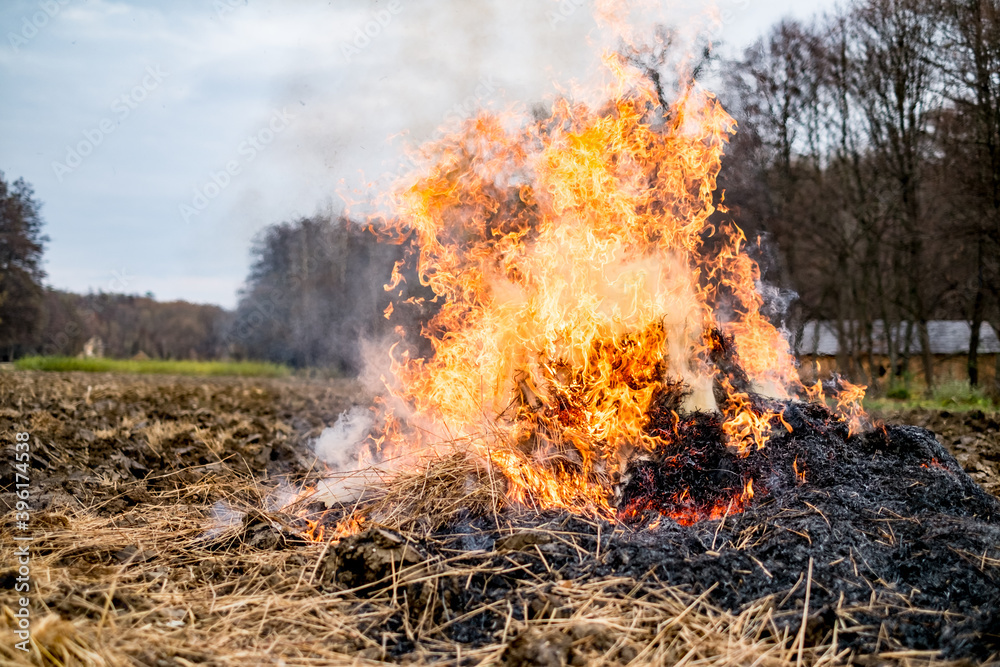 Fire burns straw field after harvest
