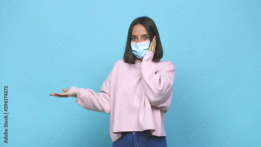 Young hispanic woman wearing antiviral mask doubting between two options Young hispanic woman wearing antiviral mask doubting between two options