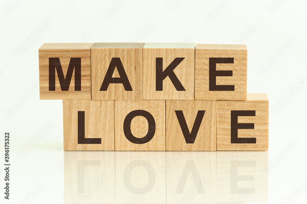 Make Love - text on wooden cubes on a white gradient background