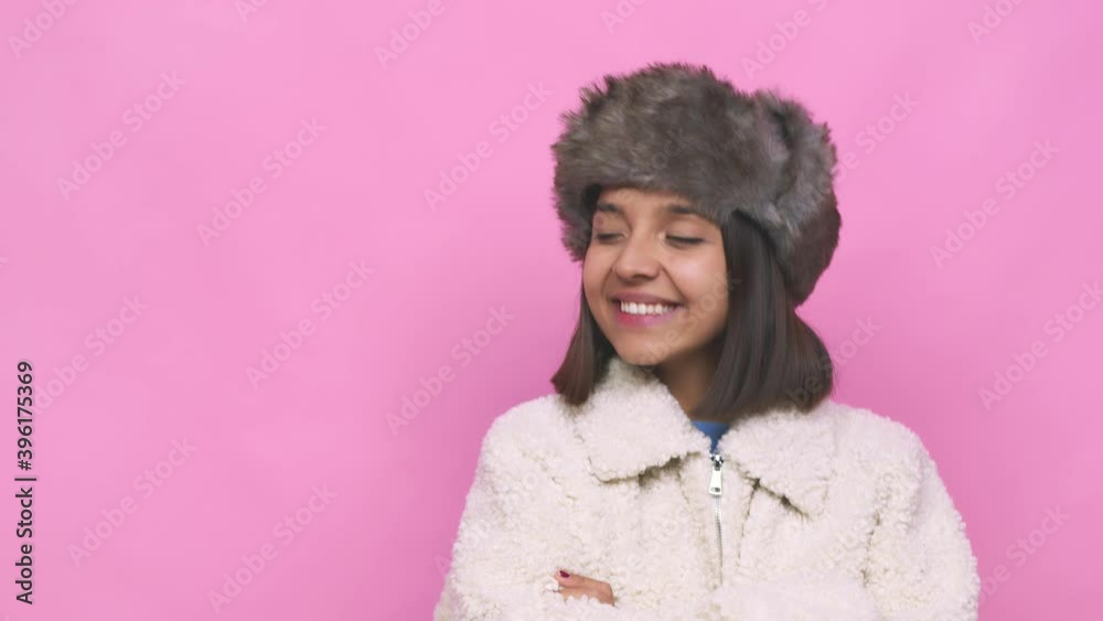 Young hispanic woman wearing a winter hat face closeup making up plan in mind, setting up an idea Young hispanic woman wearing a winter hat face closeup making up plan in mind, setting up an idea