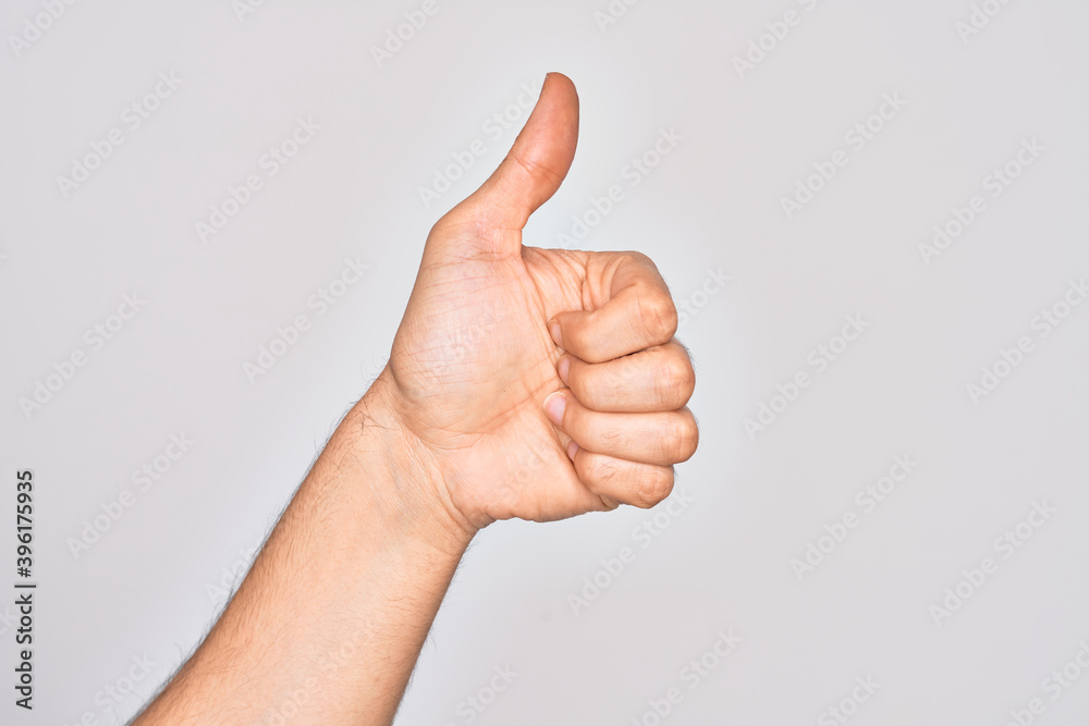 Hand of caucasian young man showing fingers over isolated white background doing successful approval gesture with thumbs up, validation and positive symbol