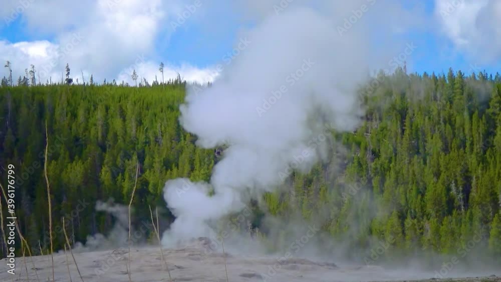 Geyser Old Faithful erupts in Yellowstone National Park in Wyoming, USA