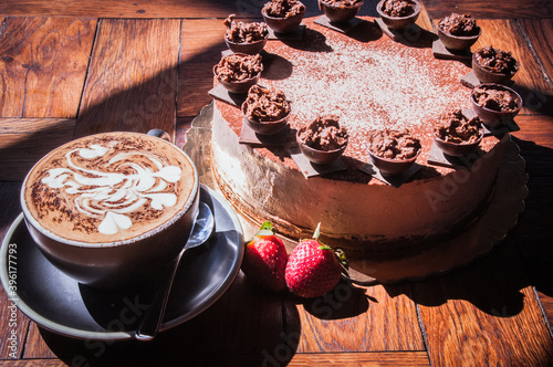 Ferrero Rocher cake on a wooden table with coffee - var 2