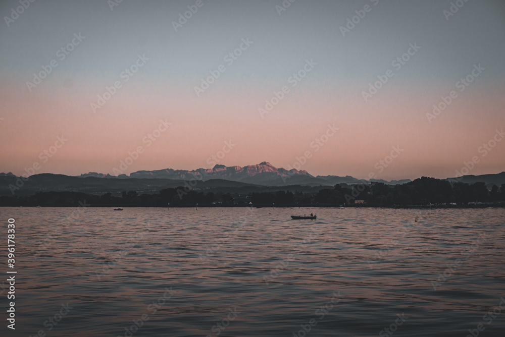 sunset over the lake with mountains in the background - landscape
