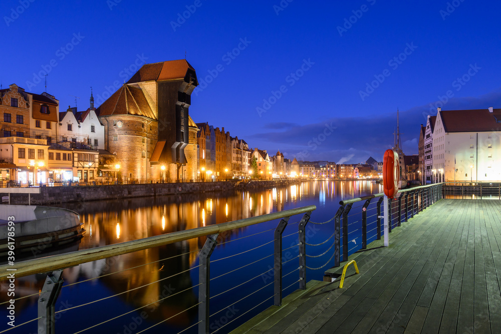 Famous old port crane of Gdansk and Motlawa River at night. Poland, Europe.