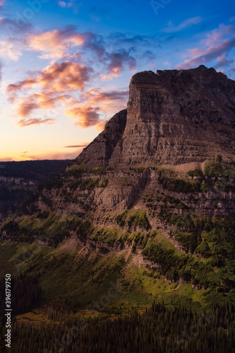 Beautiful View of American Rocky Mountains during Cloudy Summer Sunset or Sunrise. Dramatic Sky Composite. Landscape  Glacier National Park  Montana  United States.