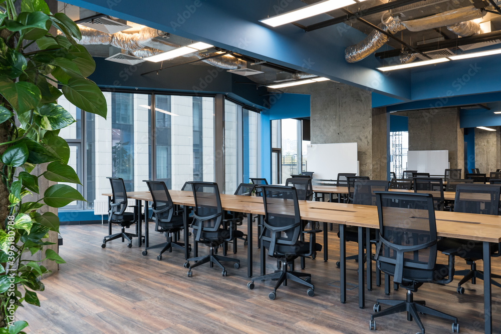 Fototapeta premium Modern office space with tables and chairs