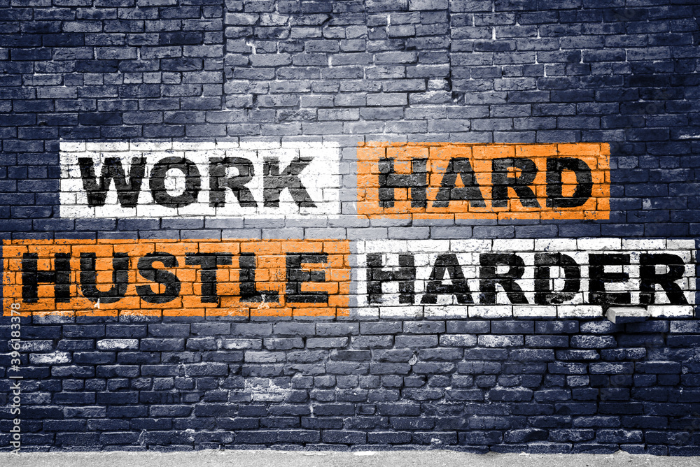 Fototapeta premium Work Hard Hustle Harder saying lettering Graffiti on Brick Wall