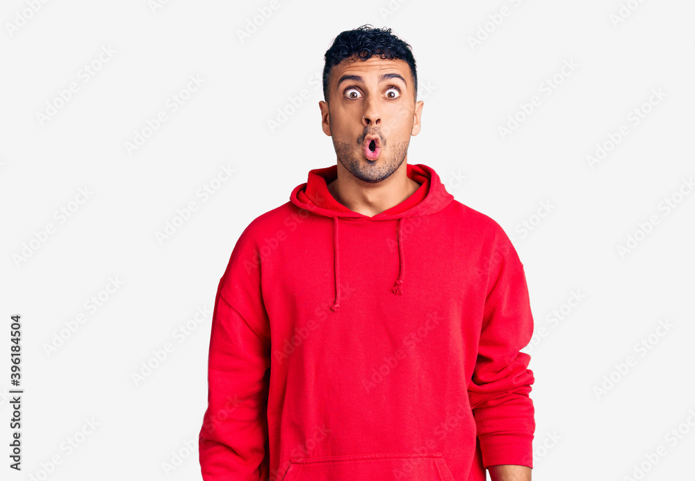 Young hispanic man wearing casual clothes scared and amazed with open mouth for surprise, disbelief face Young hispanic man wearing casual clothes scared and amazed with open mouth for surprise, disbelief face