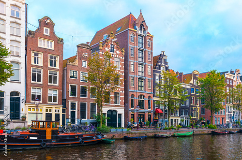 Amsterdam City Center. Beautiful view of Amsterdam Canals with Bridge and typical Dutch Houses. Netherlands.