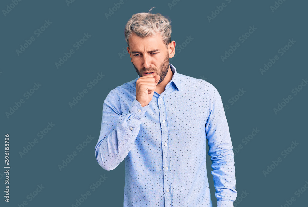 Young handsome blond man wearing elegant shirt feeling unwell and coughing as symptom for cold or bronchitis. health care concept. Young handsome blond man wearing elegant shirt feeling unwell and coughing as symptom for cold or bronchitis. health care concept.