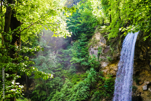 The magical feeling of a waterfall in the greenest forests on a sunny day.