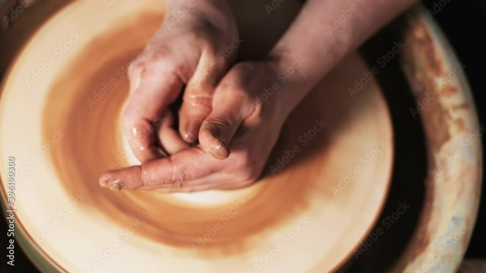 hands working clay on potter's wheel. Potter shapes the clay product with pottery tools on the potter's wheel, craft factory authentic. Close up. 4k hands working clay on potter's wheel. Potter shapes the clay product with pottery tools on the potter's wheel, craft factory authentic. Close up. 4k
