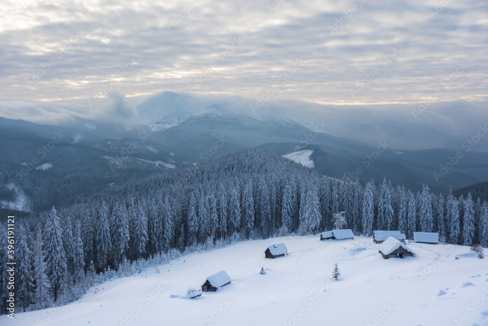 Wonderful winter in the Ukrainian Carpathian Mountains with snow-covered houses and spruce around Wonderful winter in the Ukrainian Carpathian Mountains with snow-covered houses and spruce around