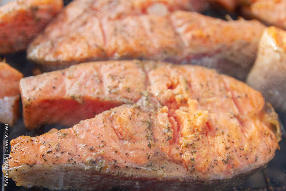 Large fish steaks fresh trout fried in spices on the grill