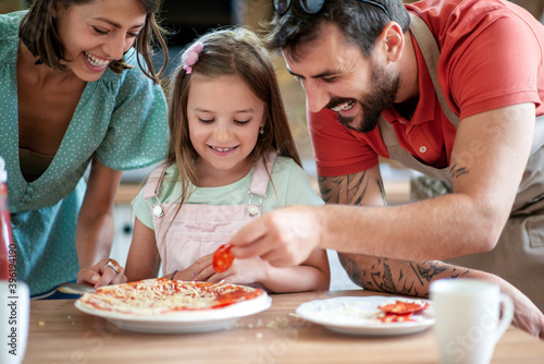 Family making pizza at home