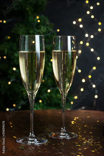 Pair glasses of champagne on holiday background with color decoration