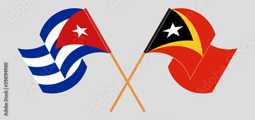 Crossed and waving flags of Cuba and East Timor