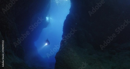 Wallpaper Mural cave diving underwater scuba divers exploring caves ocean scenery sun beams and rays background Torontodigital.ca