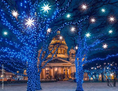Saint-Petersburg on a winter evening. Festive Petersburg. Christmas in Russia. St. Petersburg is decorated for the New year. St. Isaac Cathedral in winter. Trees with garlands on city streets.